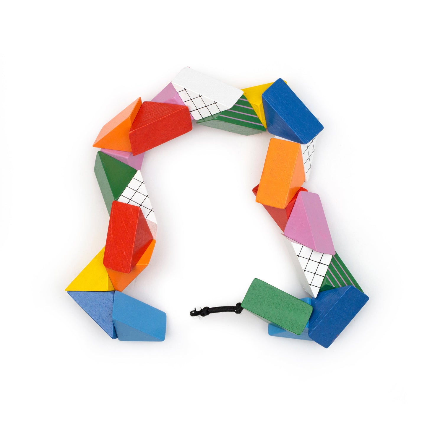Colorful geometric puzzle pieces with white grid faces, linked in a ring with cord
