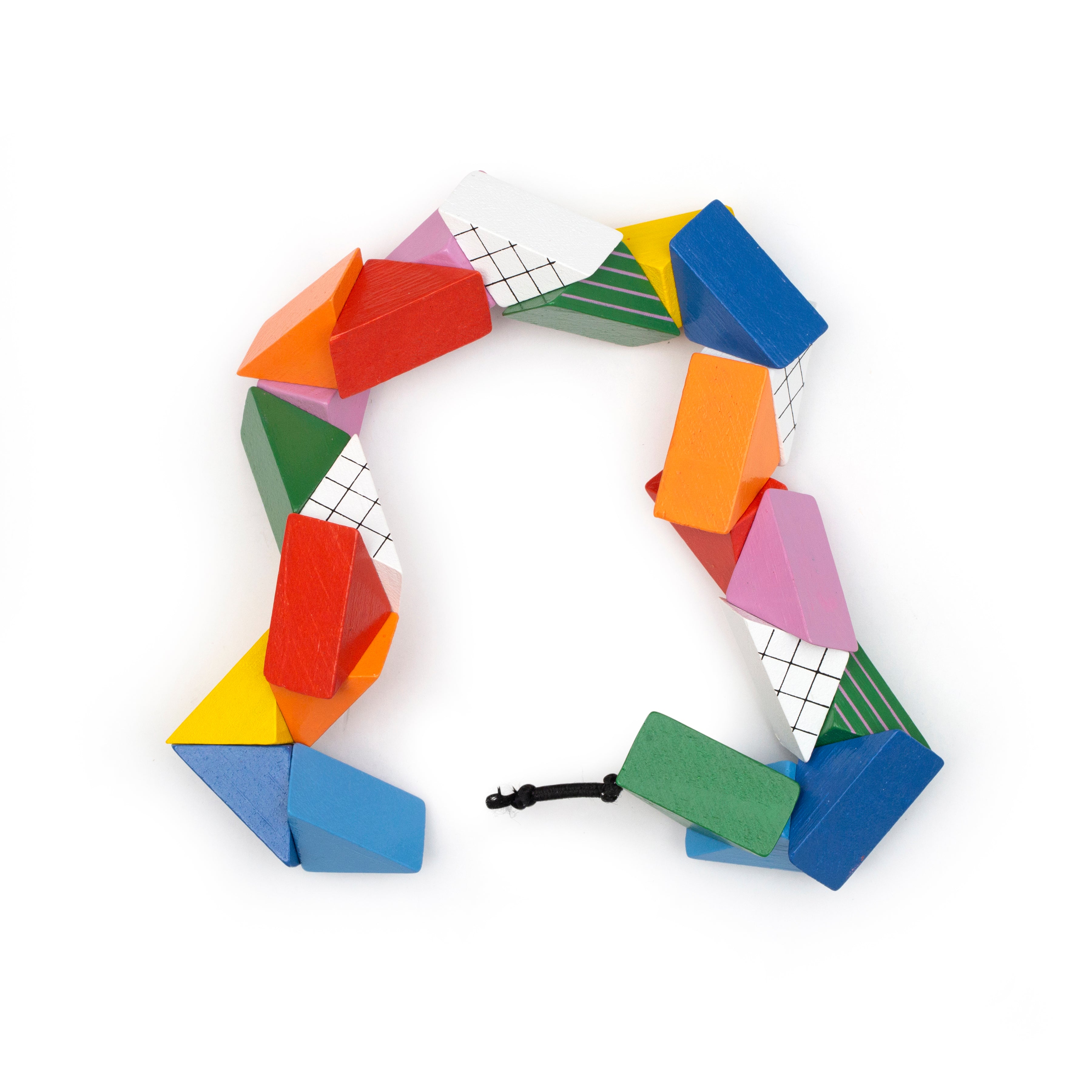 Colorful geometric puzzle pieces with white grid faces, linked in a ring with cord