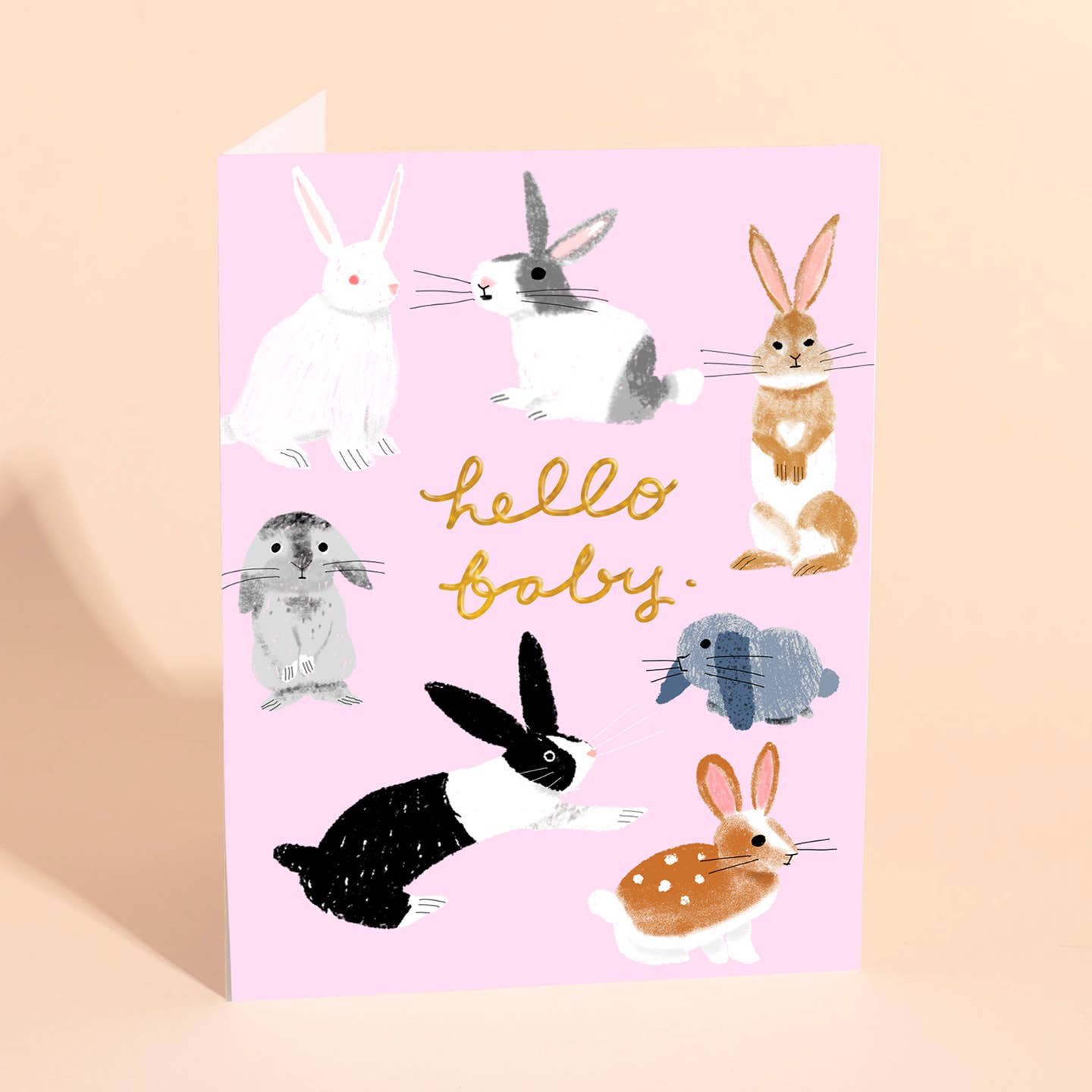 Pink baby greeting card with three cute rabbits and gold “hello baby” text