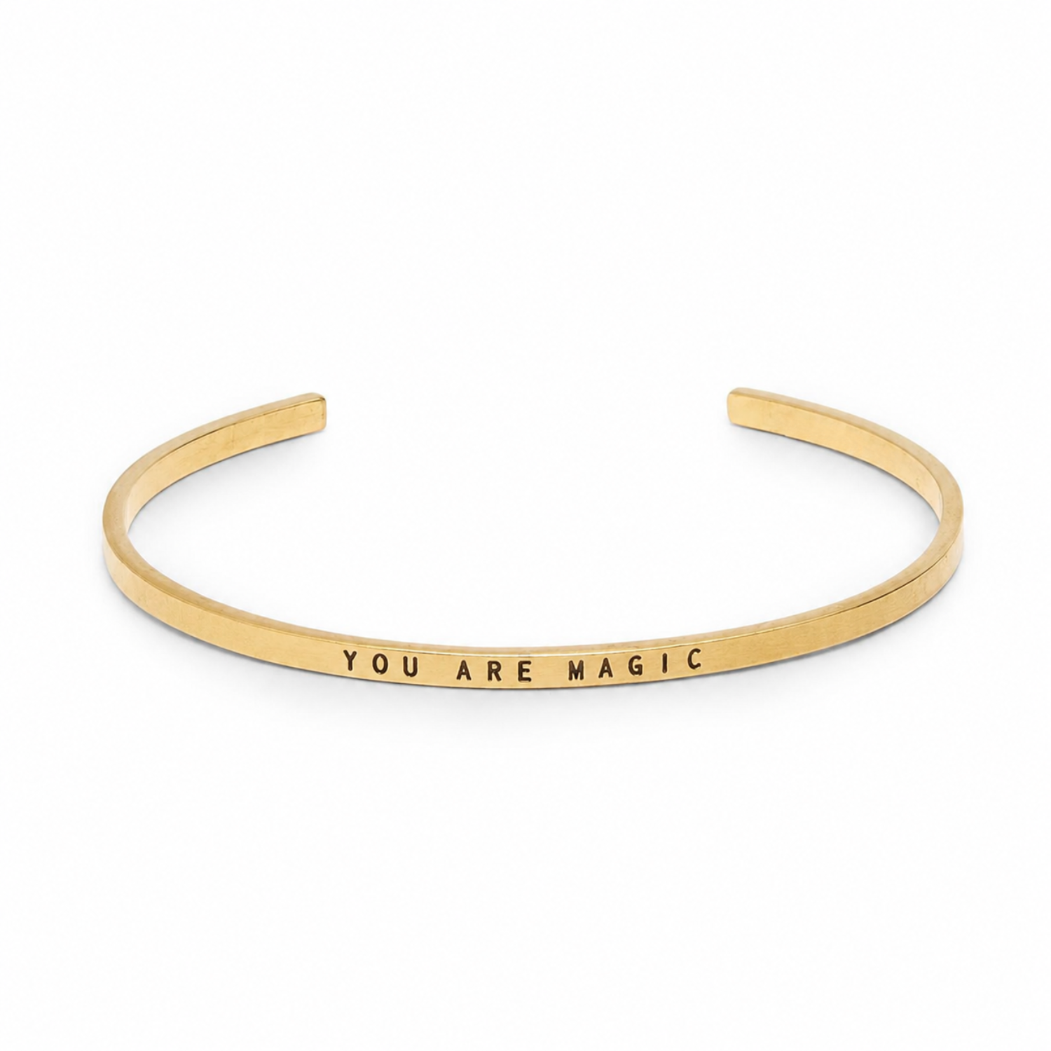 Narrow thin gold cuff bracelet stamped with “YOU ARE MAGIC”
