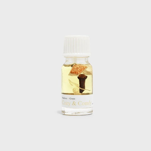 Essential oil blend bottle with white cap, amber liquid, label reads Cozy & Comfy.