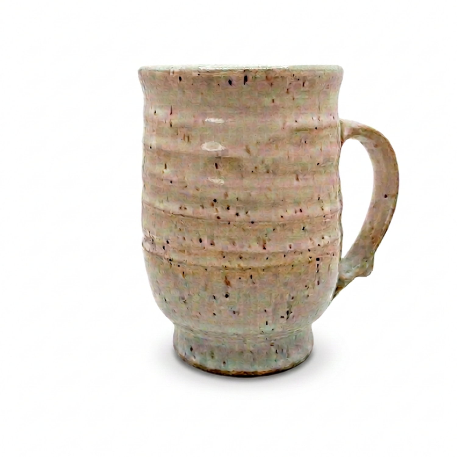 Speckled ceramic mug with curved handle, beige glaze with dark flecks