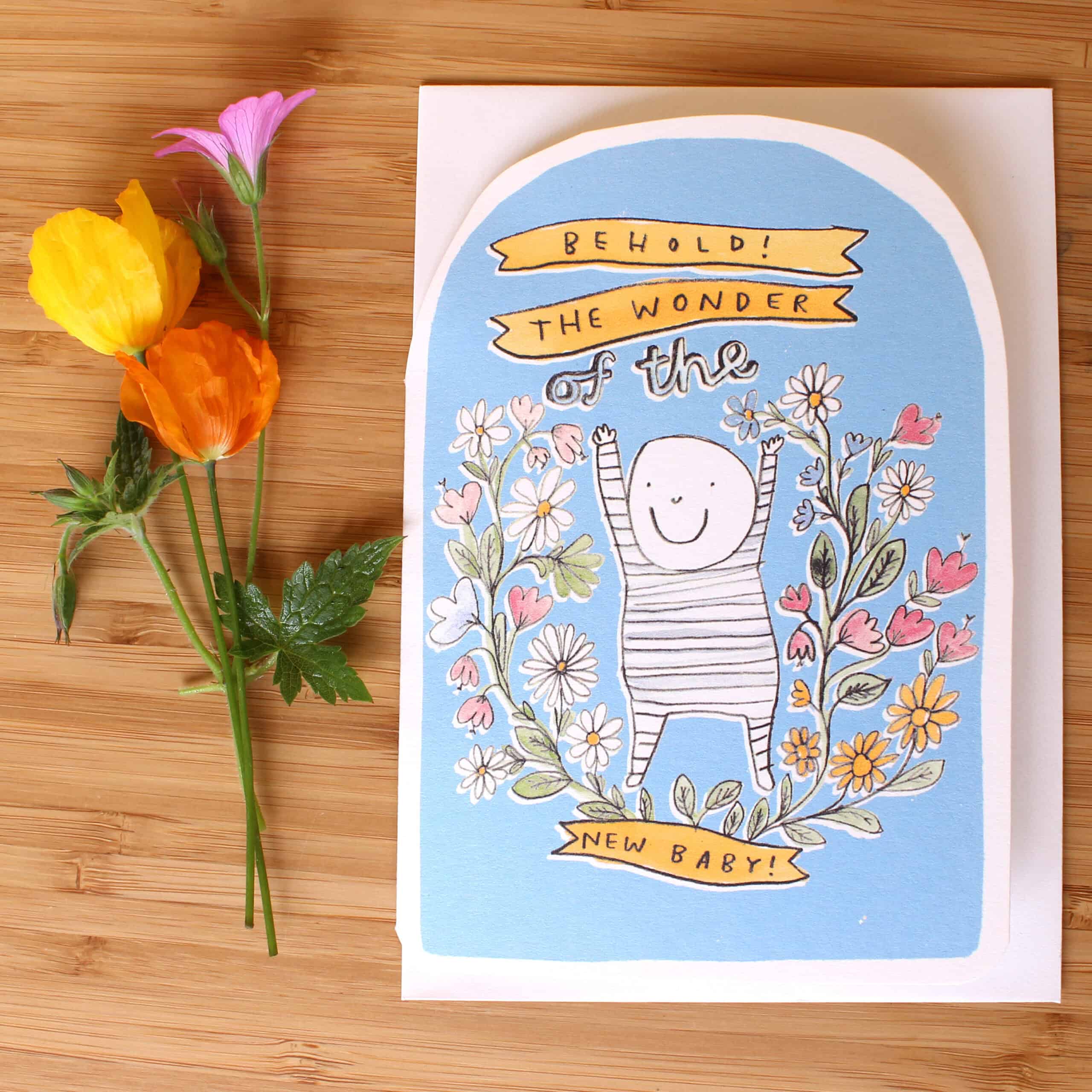 New baby greeting card with blue arch, smiling baby illustration, and colorful flowers
