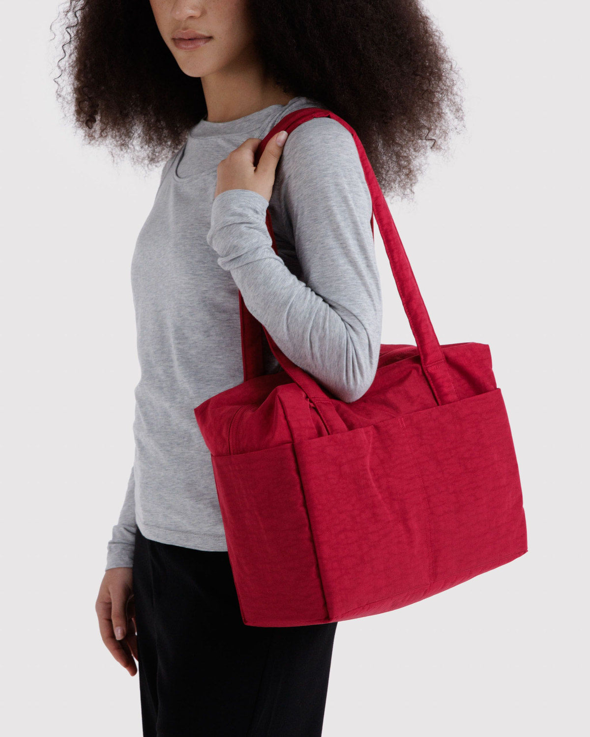 Red fabric tote bag with wide handles and zippered top