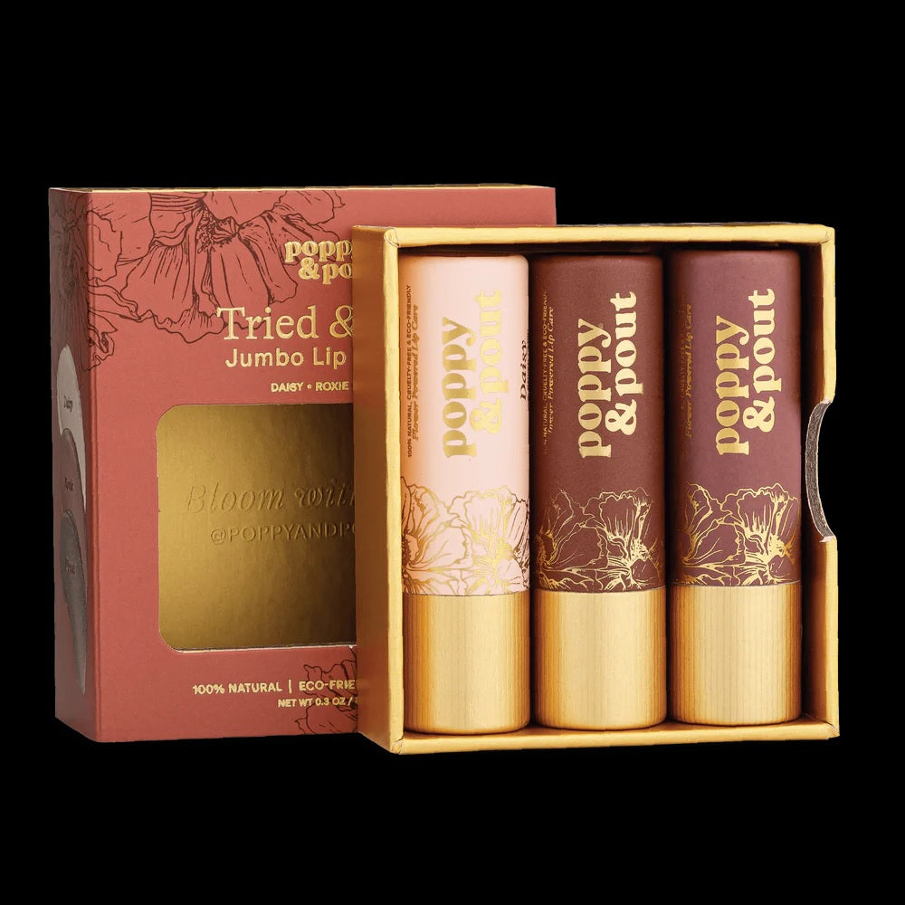 Opened lip tint gift set with three patterned tubes in light, rose, and brown tones