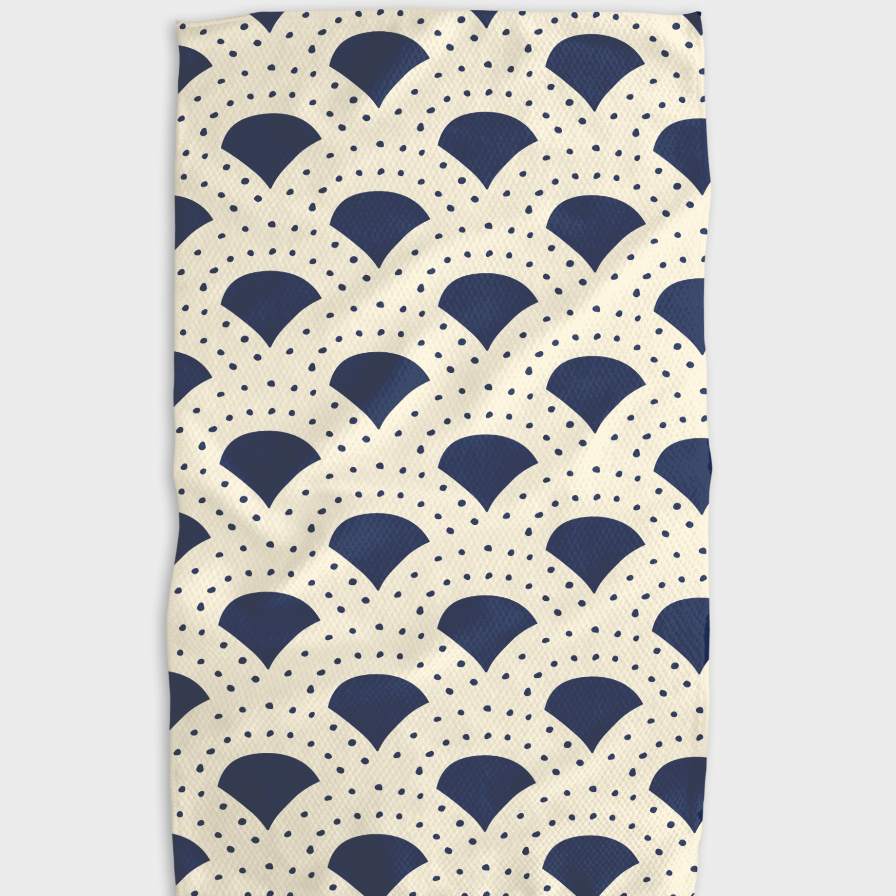 Tea towel with navy and cream fan pattern and small dot accents