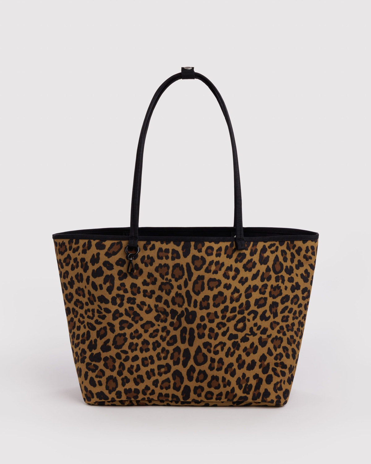 Large nylon reversible tote with leopard print exterior and black top handles
