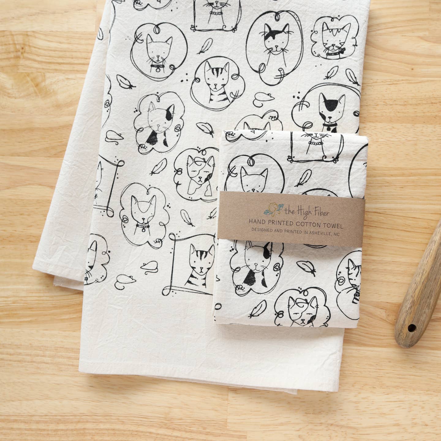 Cat kitchen tea towel with allover line-drawn cats in black on white cotton