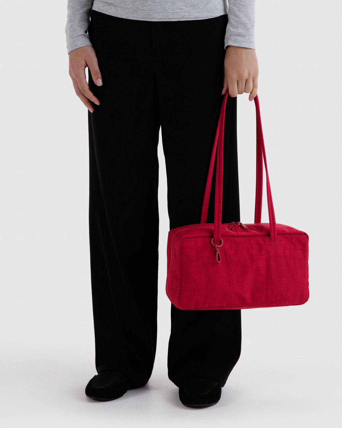 Red nylon bowler bag with double top handles and zip closure