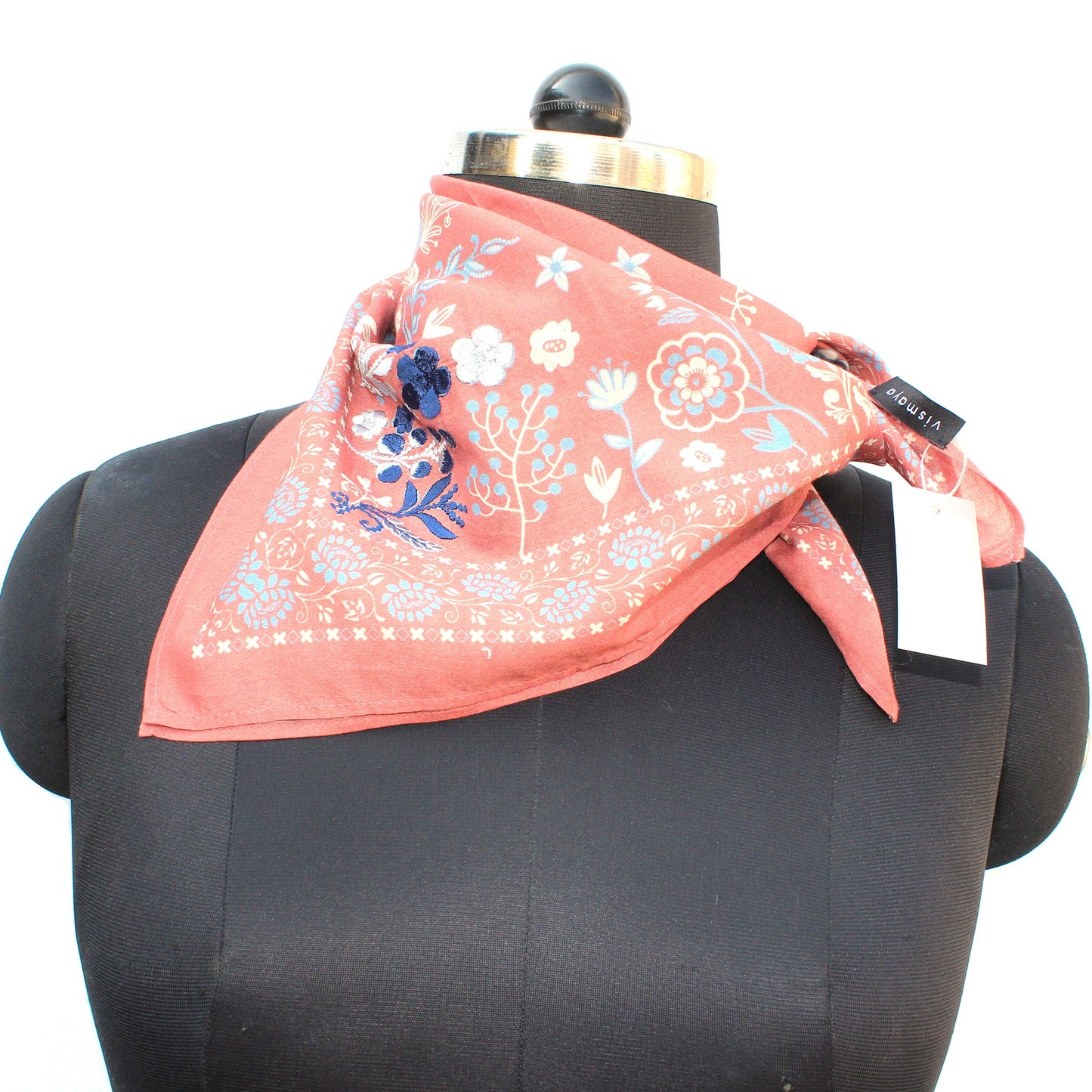 Dusty rose floral cotton scarf on mannequin, tied neatly at the neck