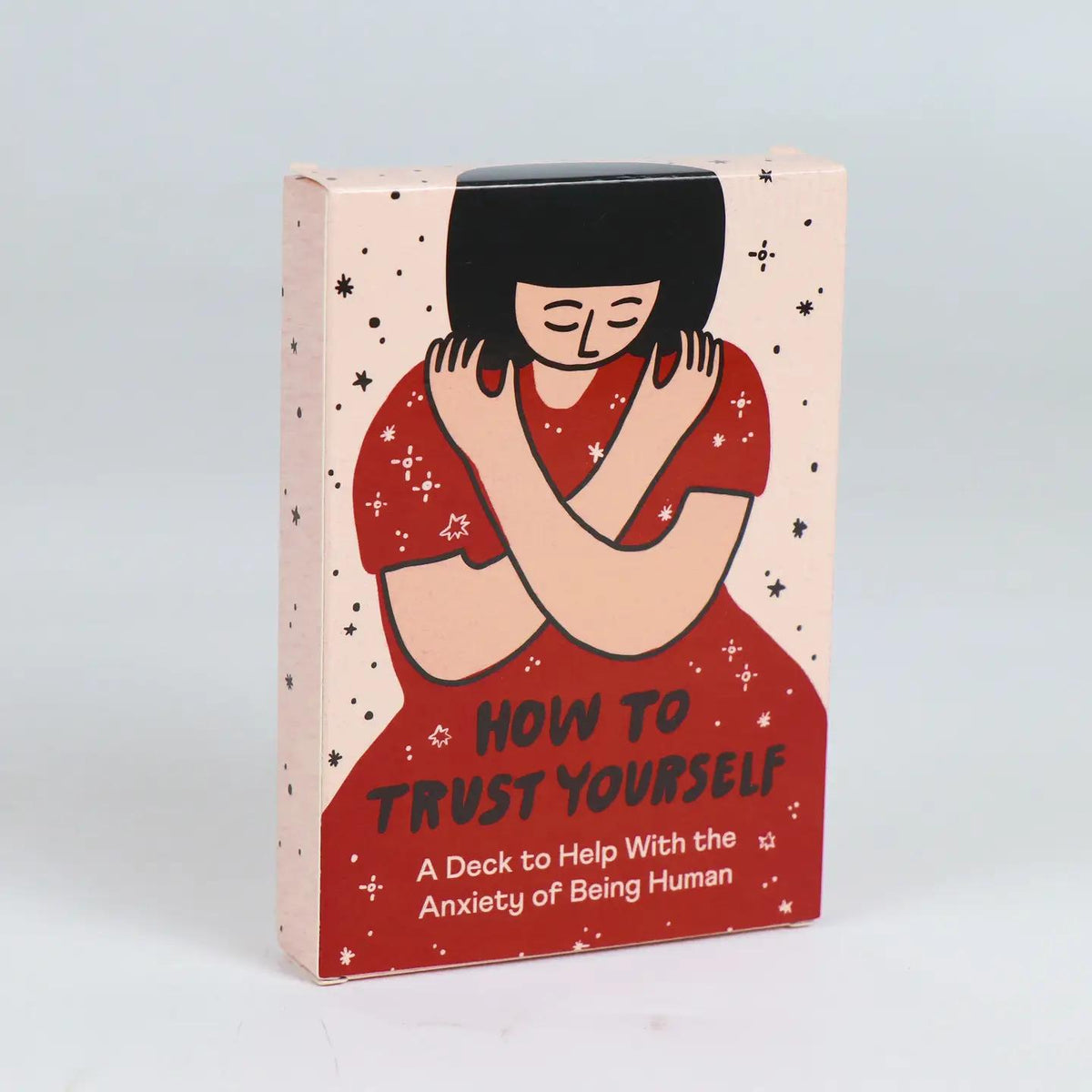 Anxiety card deck in cream and red with closed-eyed woman illustration, title text on front.