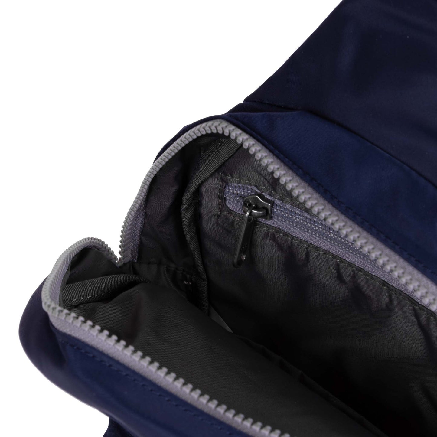 Open dark blue sling bag showing black interior lining and zippered compartment