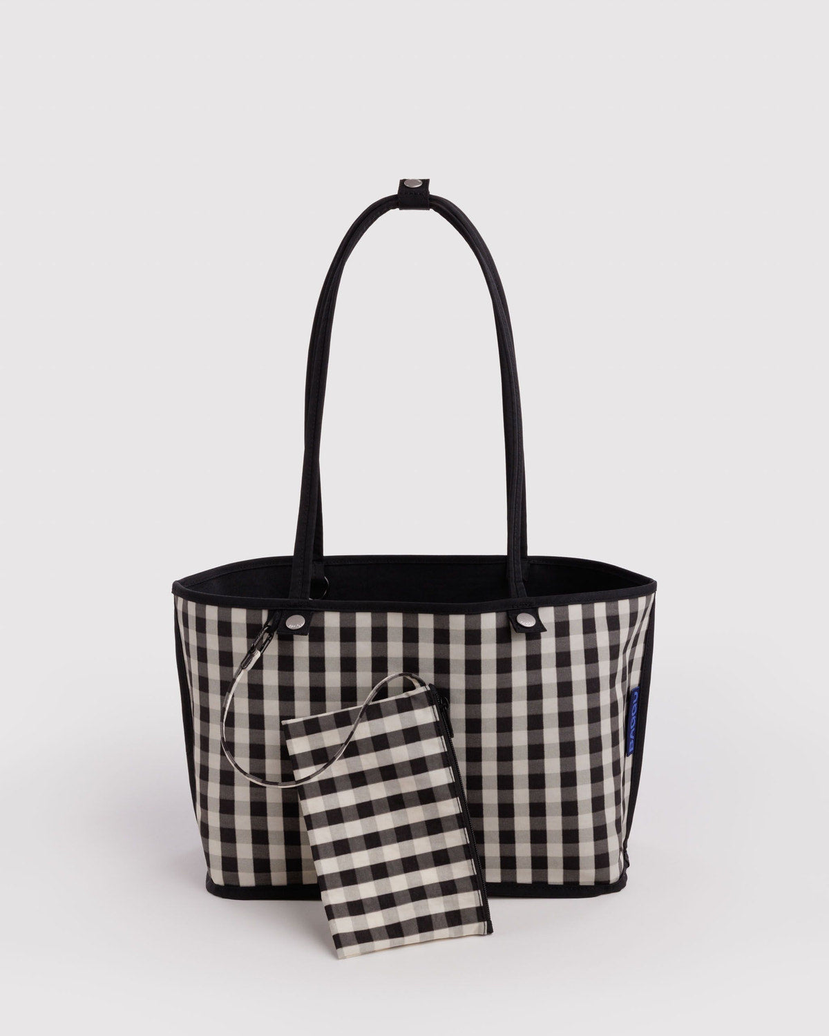 Medium reversible nylon tote with top handles, black-and-white gingham lining and pouch.
