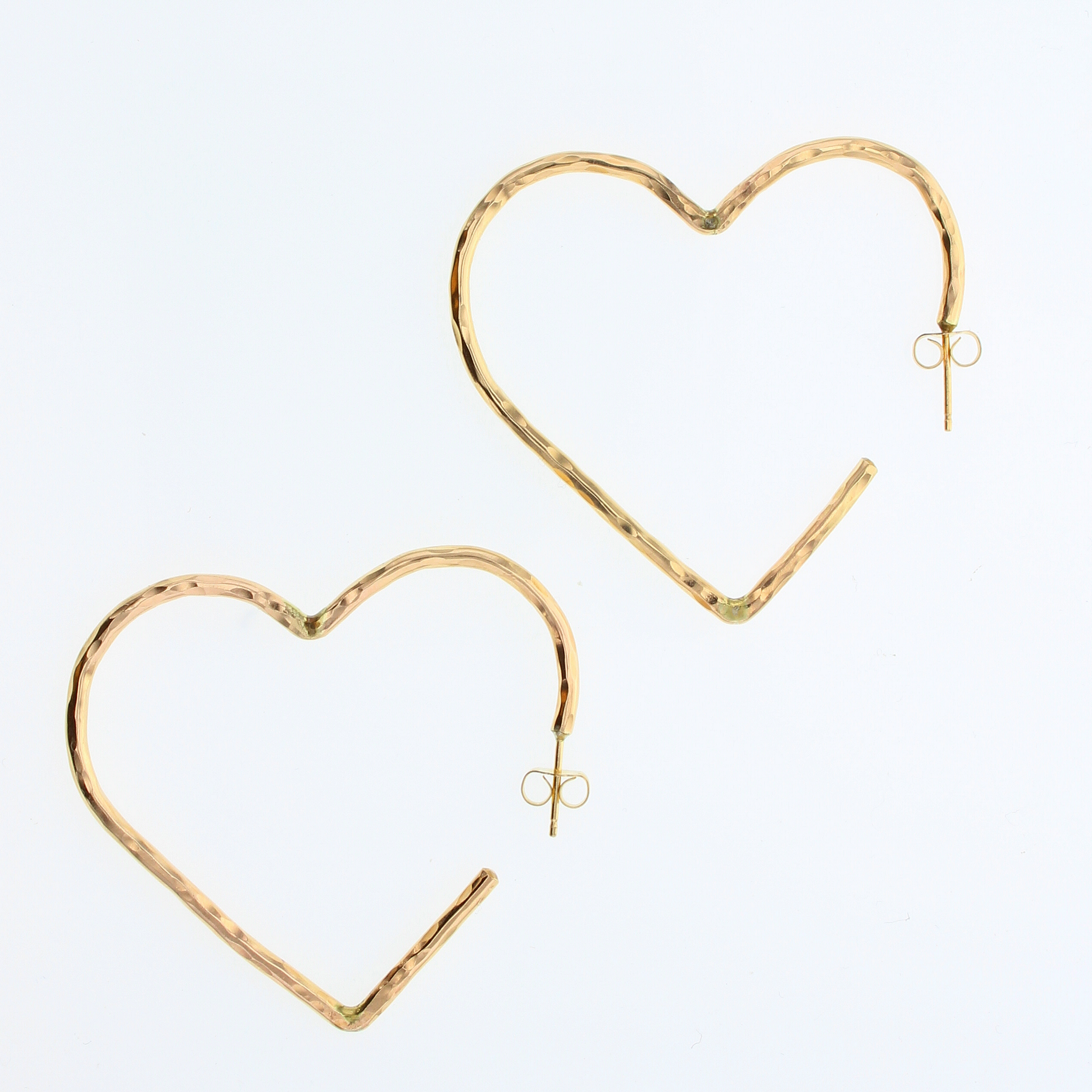 Gold heart-shaped stud earrings with small bow detail and hook closure