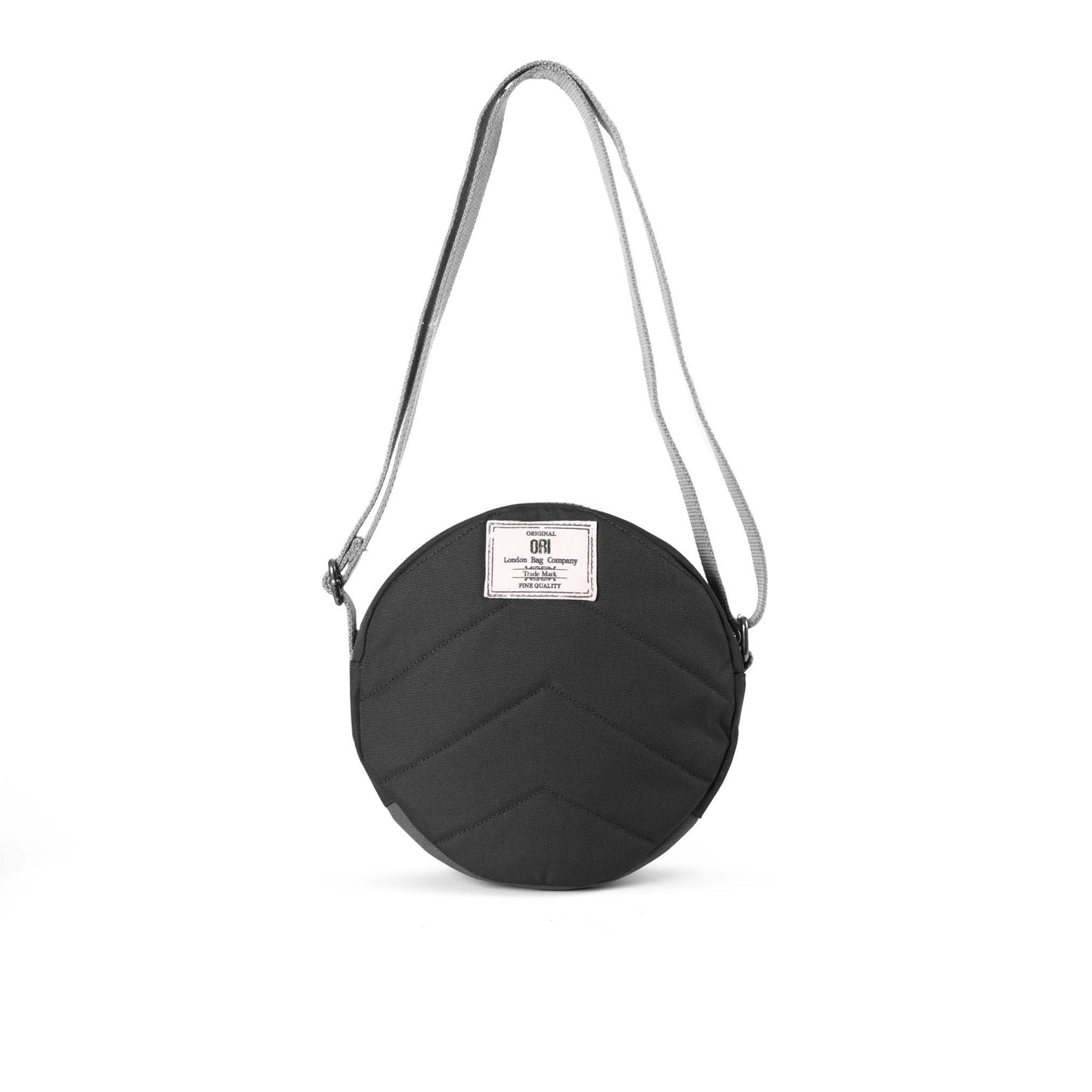 Recycled canvas crossbody bag, round black front with patch label and gray strap