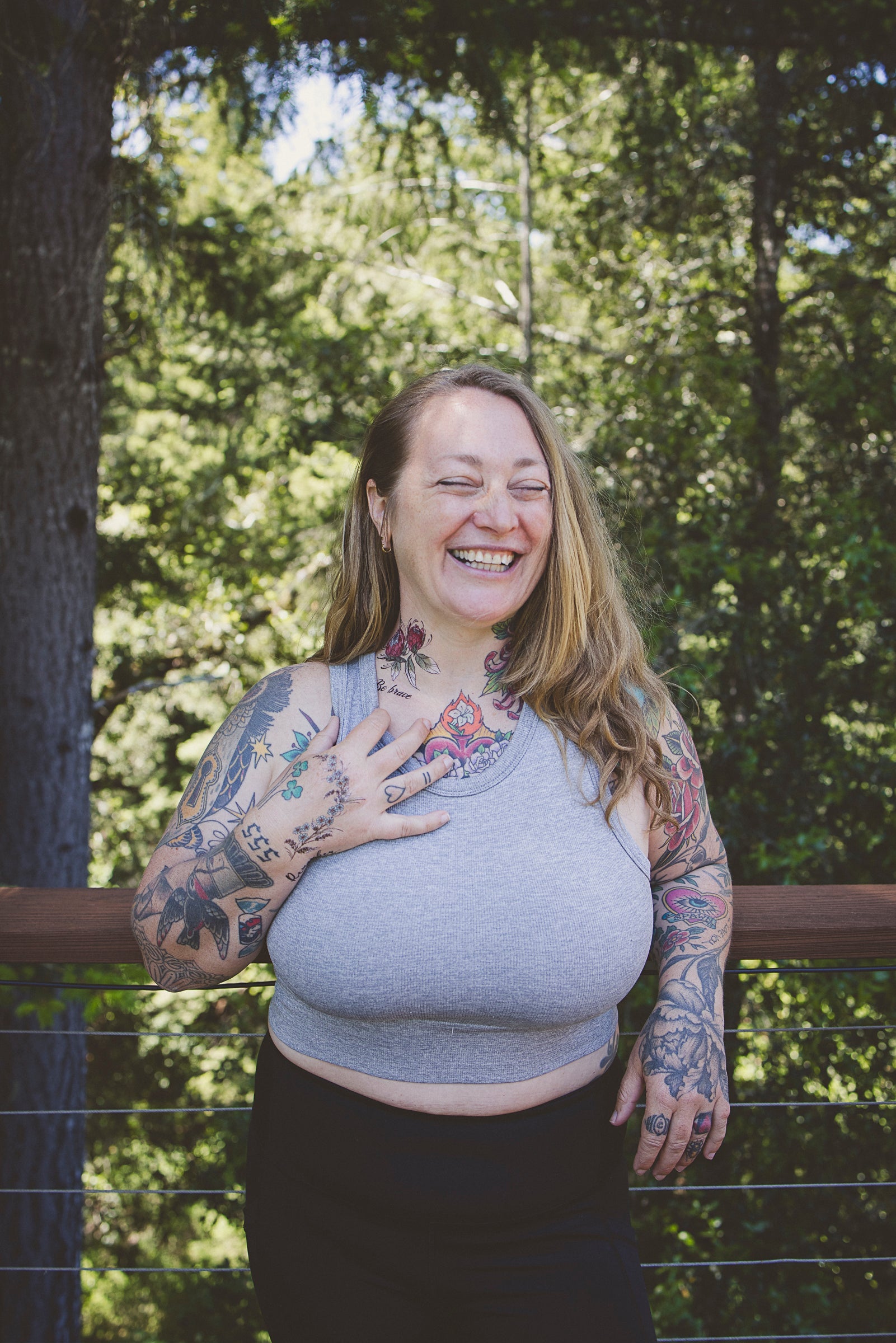 Temporary floral tattoos in blue, red, and green on left arm and chest