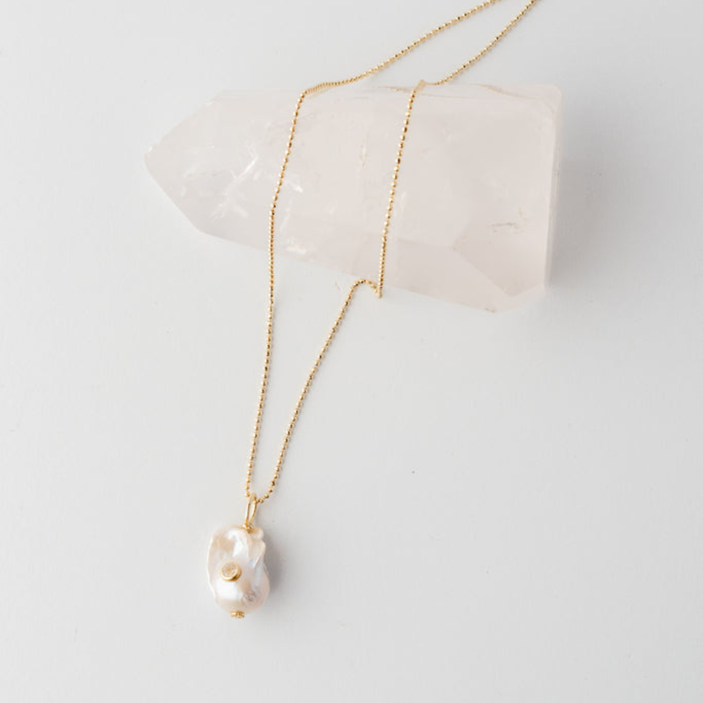 White pearl pendant on gold vermeil chain.