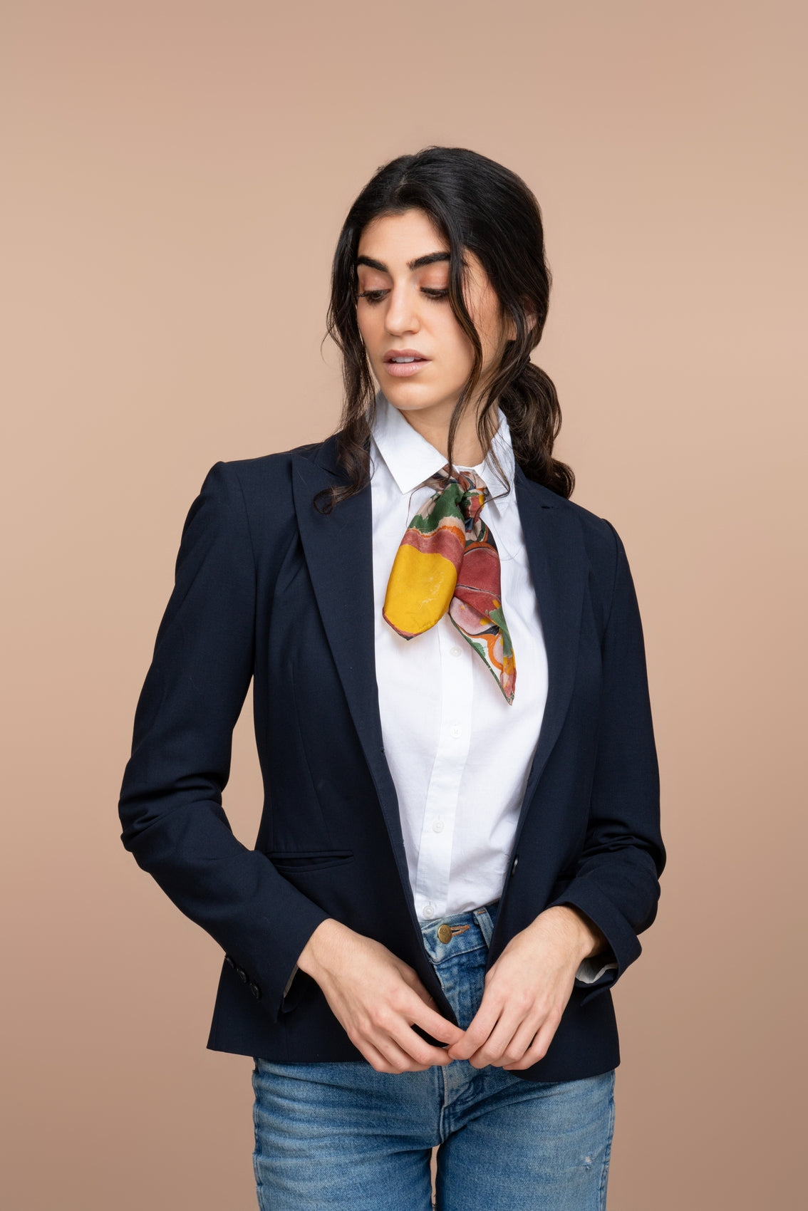 Multicolor striped bandana tied at the neck, with abstract circle and wave motifs