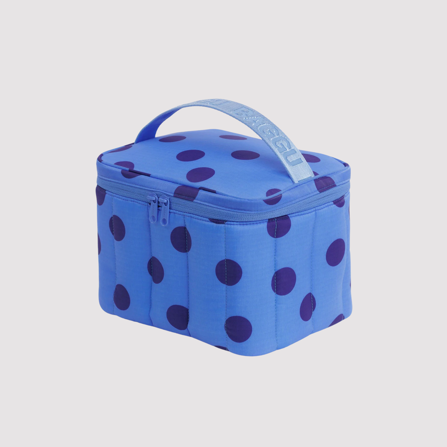 Puffy lunch bag in blue with purple polka dots, hinged lid and carry handle.