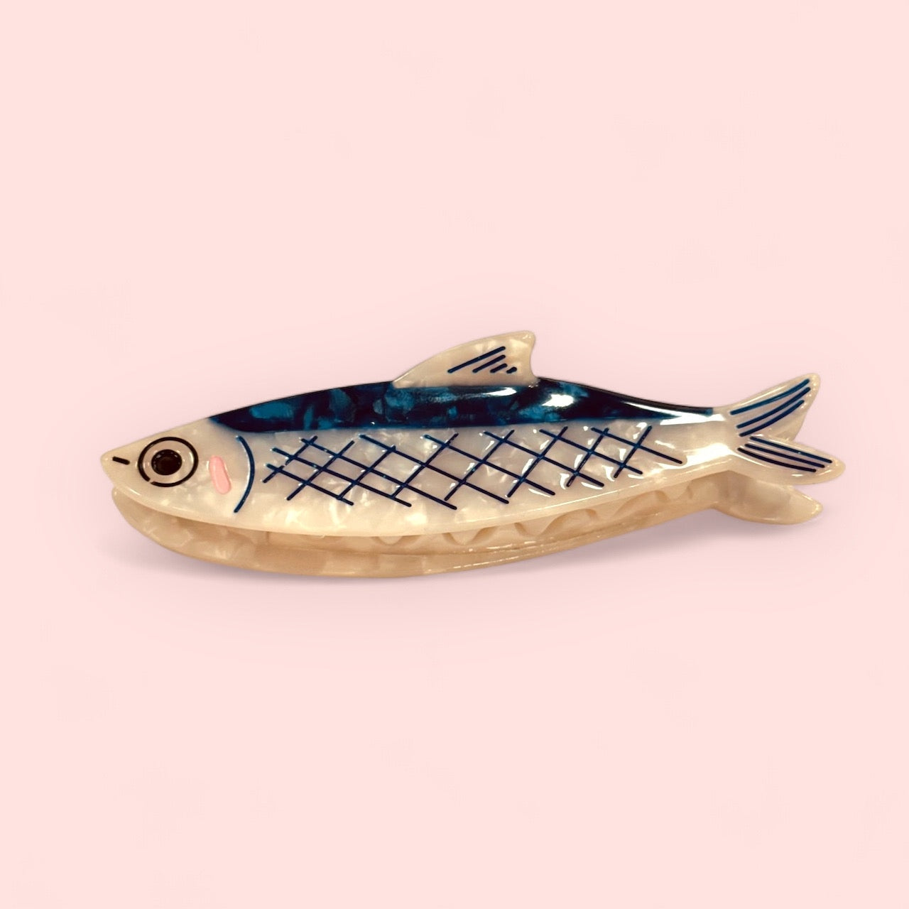 Fish-shaped hair claw with blue grid pattern and cream base, secure clip style