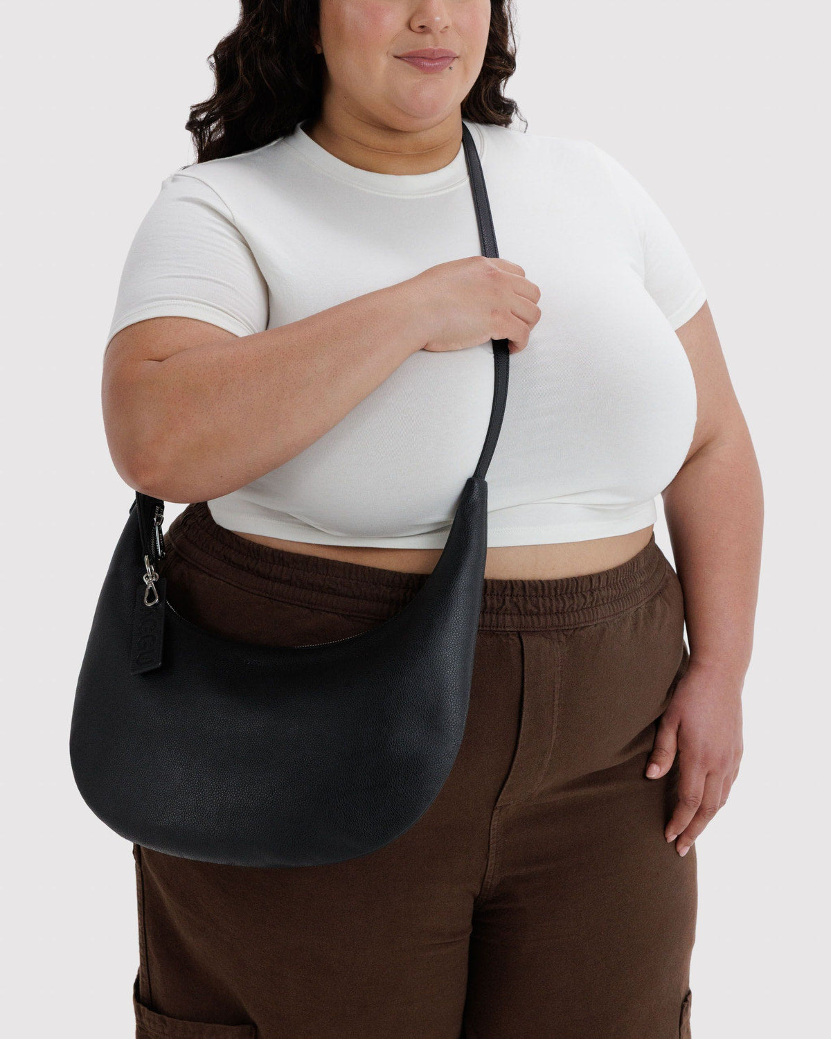 Medium crescent hobo bag in black recycled leather, crescent shape with zip top