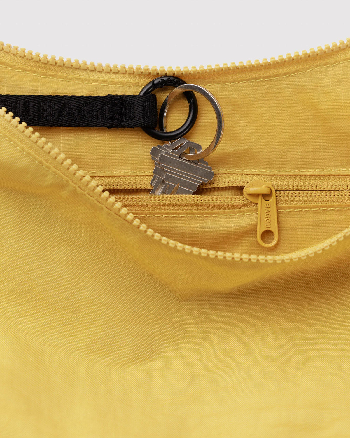 Medium nylon crescent bag interior in mustard yellow with zipper, key ring, D-ring
