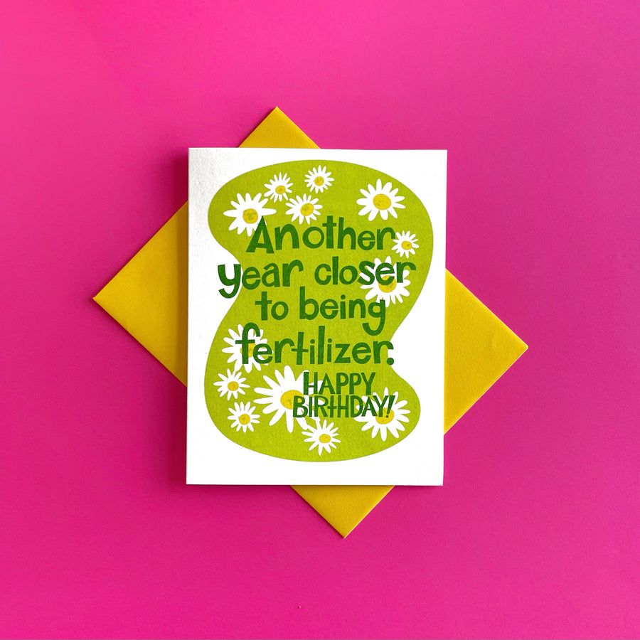 Birthday card with green daisy circle and 'Happy Birthday' message