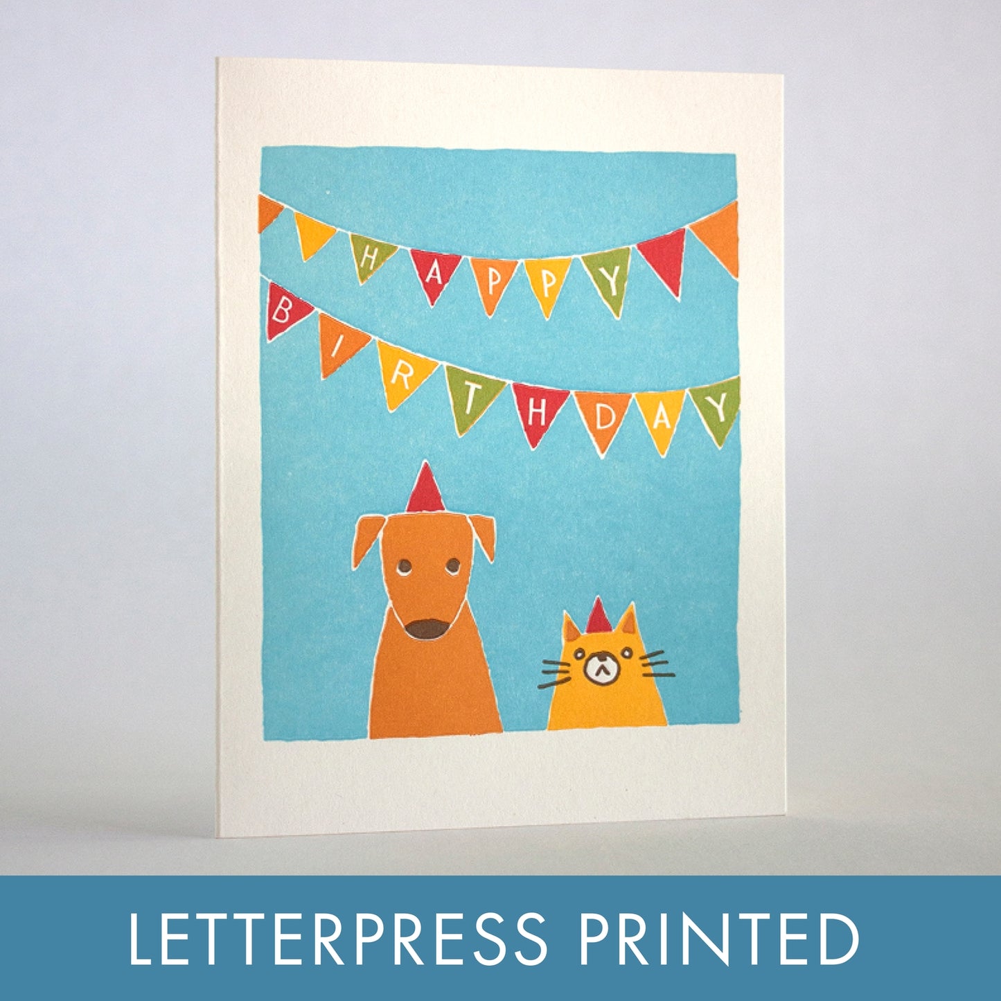 Birthday letterpress card with blue panel, orange dog and cat under Happy Birthday bunting