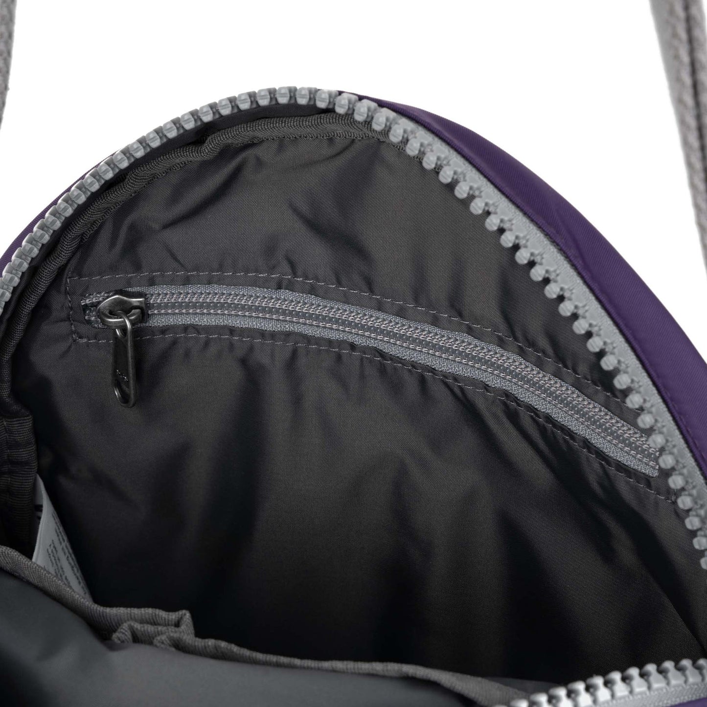 Recycled canvas crossbody bag with dark interior lining and purple trim zipper edge