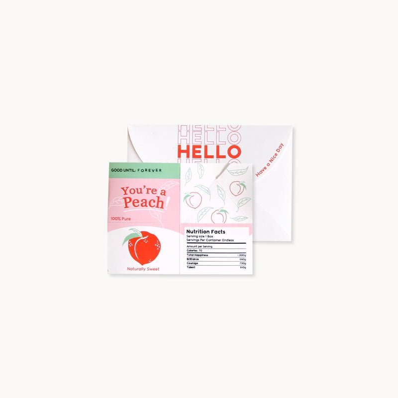 Juice box pop-up greeting card partially open, showing 'HELLO' and peach nutrition panel