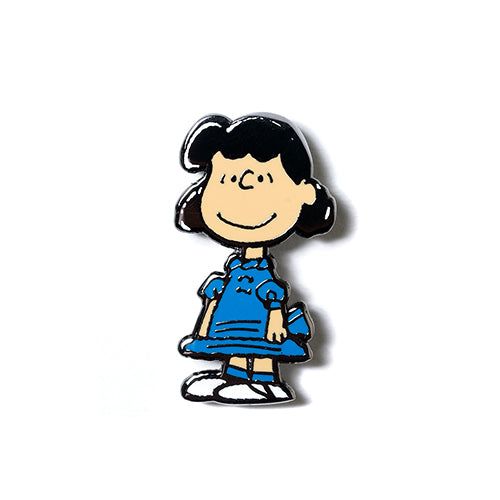 Lucy Peanuts enamel pin with smiling girl in blue outfit and striped dress