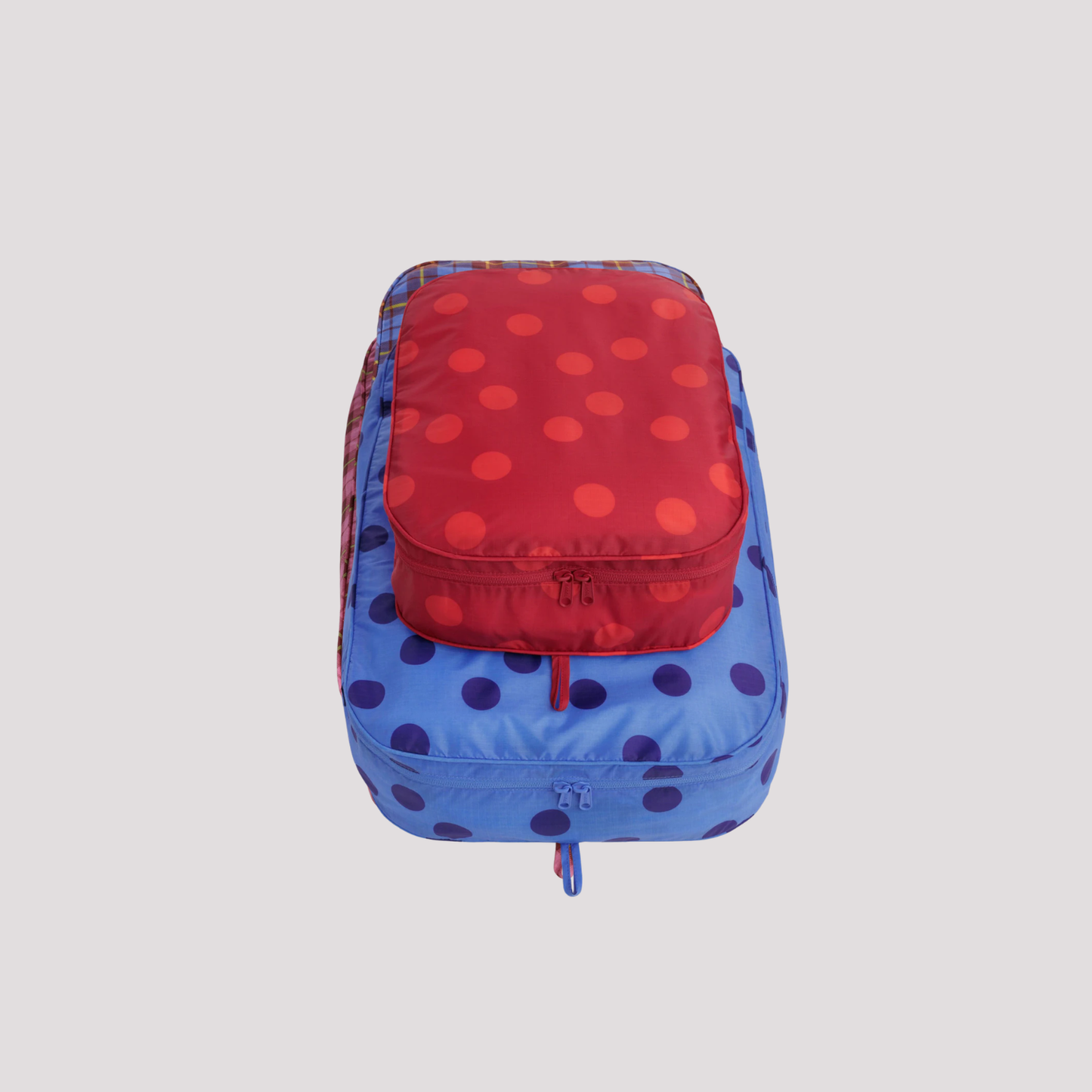 Large packing cube with blue base and red polka-dot top, zip closure