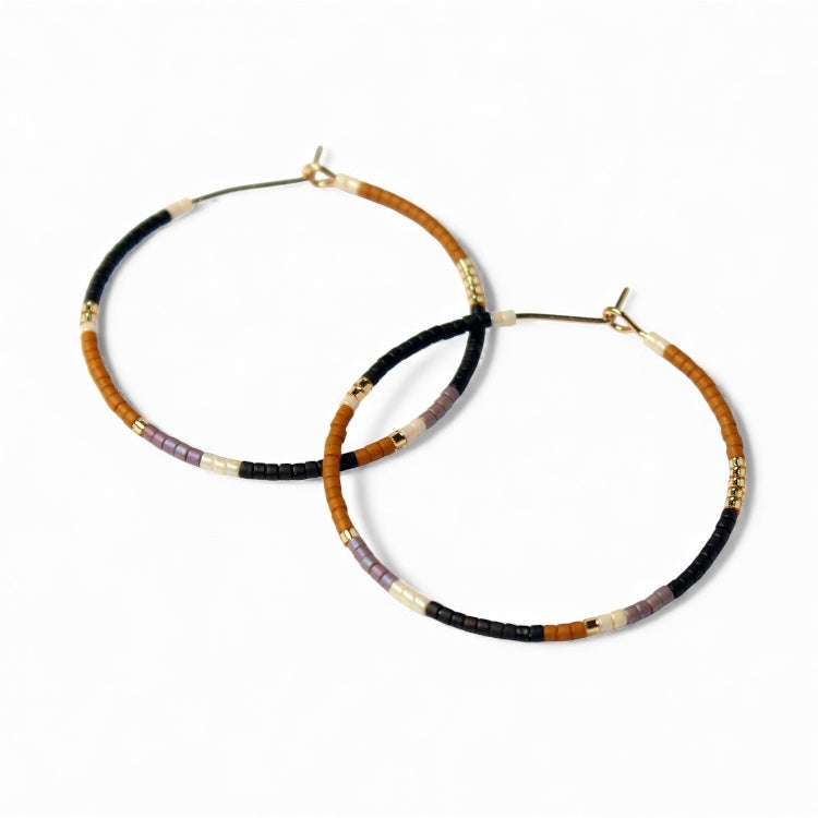 Beaded hoop earrings with black, brown and gold-toned bead accents