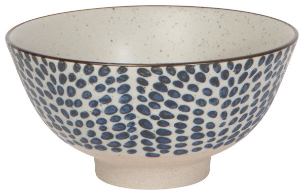 Large ceramic bowl with speckled cream glaze and blue droplet dot pattern; footed base