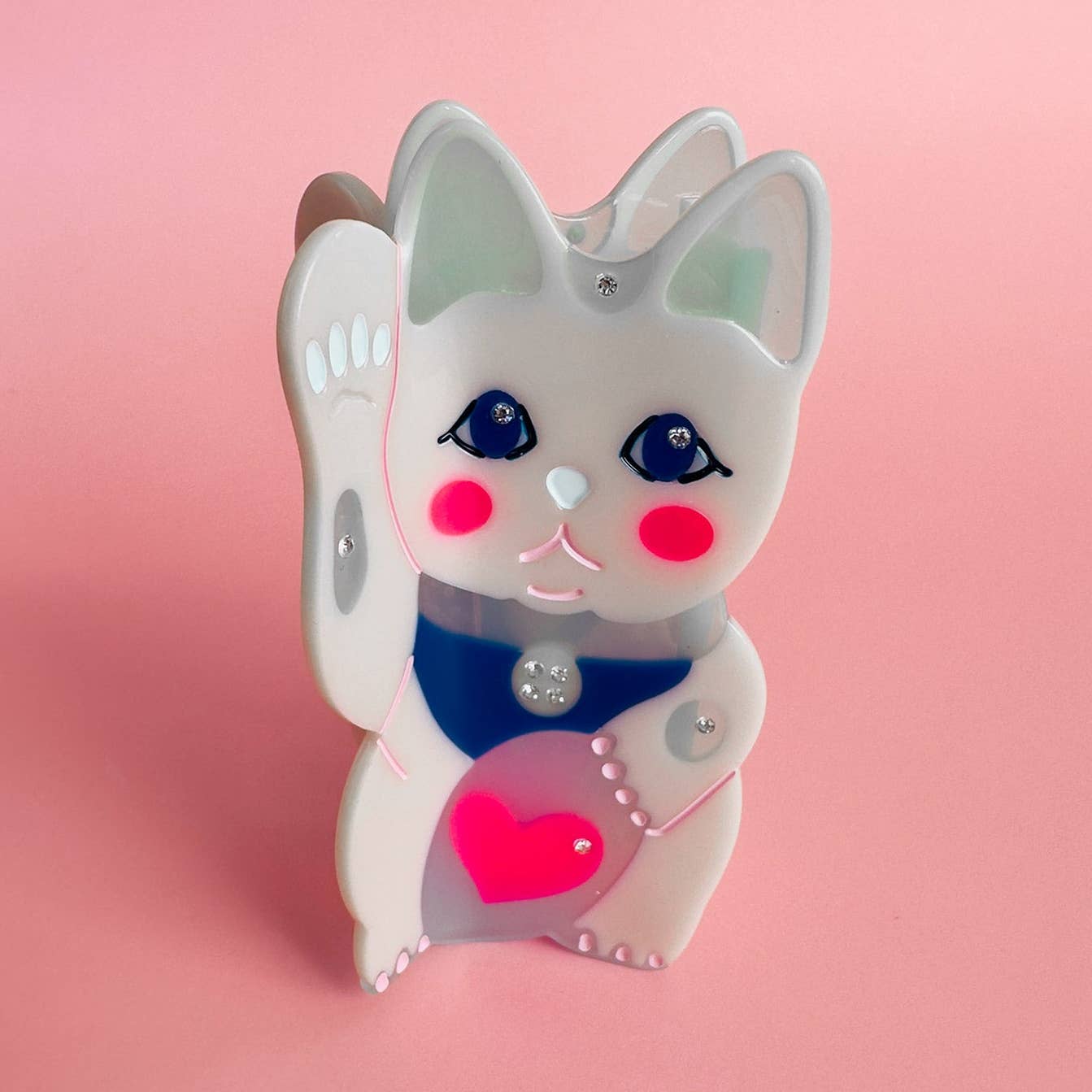 White lucky cat hair claw with blue eyes, pink heart, and navy outfit
