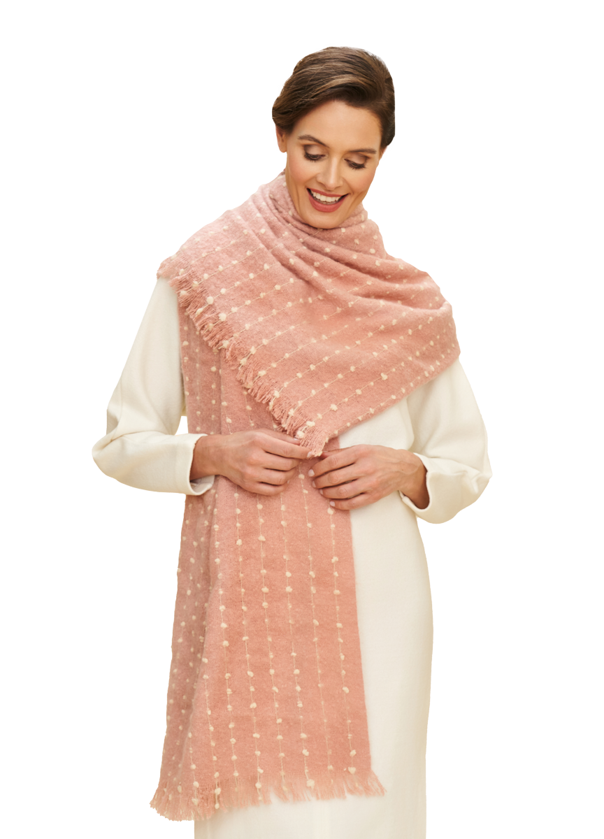 Petal Pink scarf draped on model, dotted stripe pattern, fringe ends