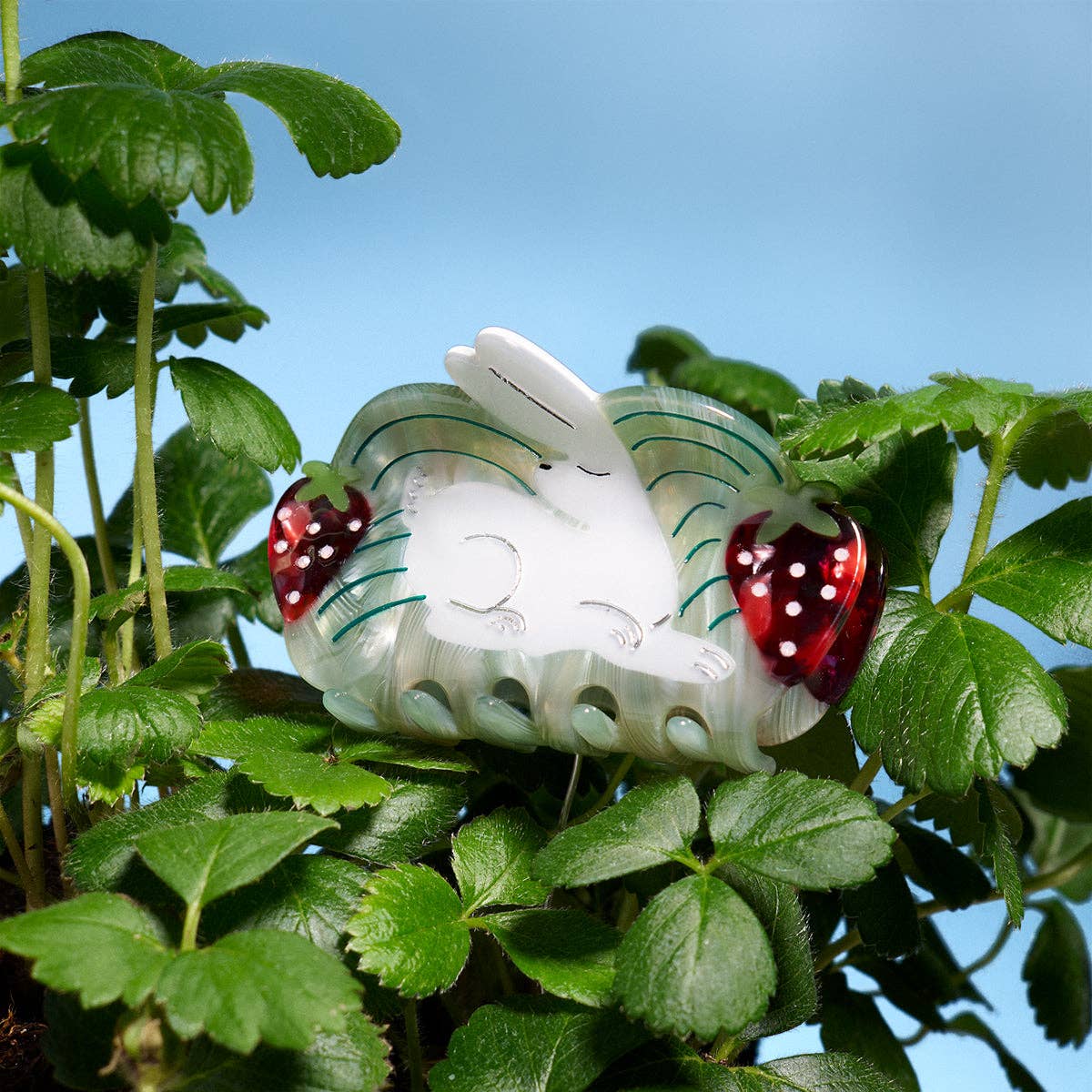 Rabbit hair claw with mint green translucent base, white rabbit, and red dotted strawberries