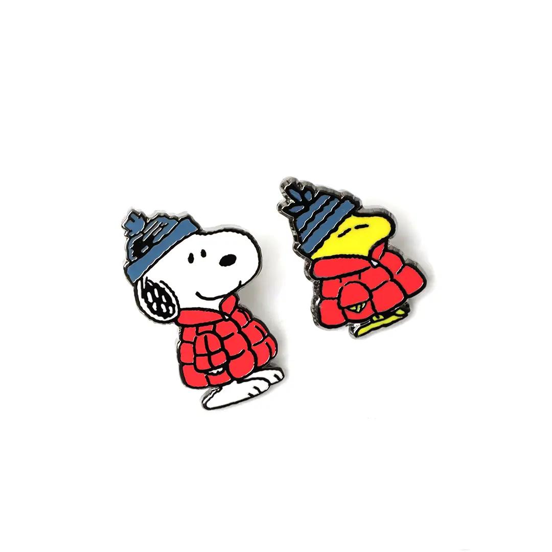 Two character lapel pins: Snoopy and Woodstock in red puffer jackets