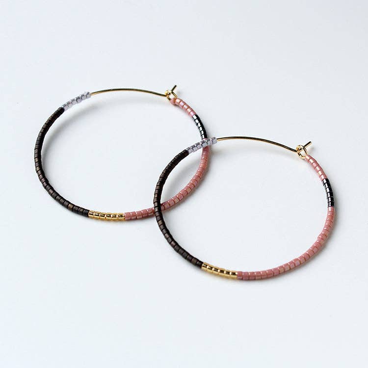 Beaded hoop earrings with black, pink and gold accents, small stud closures