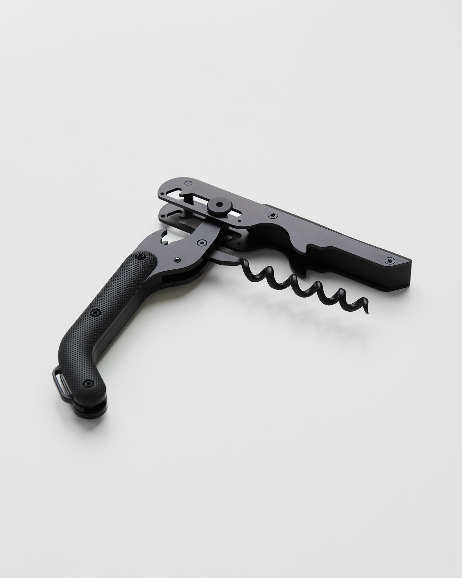 Compact wine corkscrew with dark handle, silver head, and spring-loaded lever