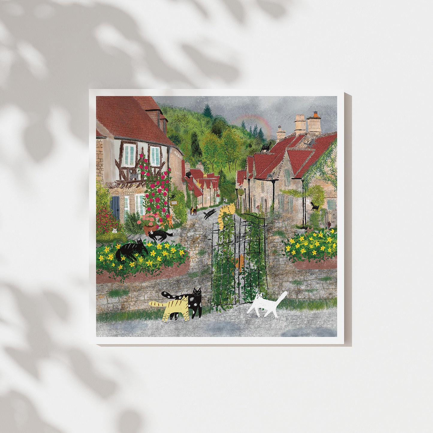 Unframed art print of cats in a colorful village garden courtyard