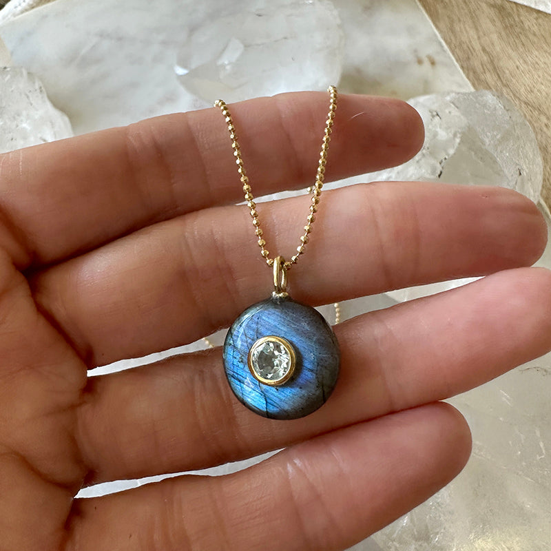 Round blue labradorite pendant with clear blue topaz center on gold vermeil chain.