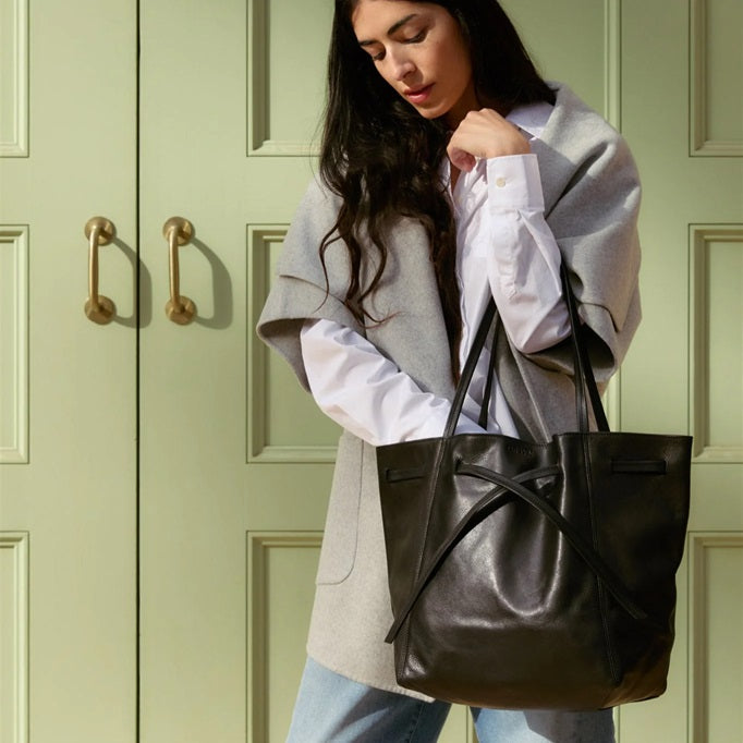 Black leather drawstring tote bag with adjustable top ties