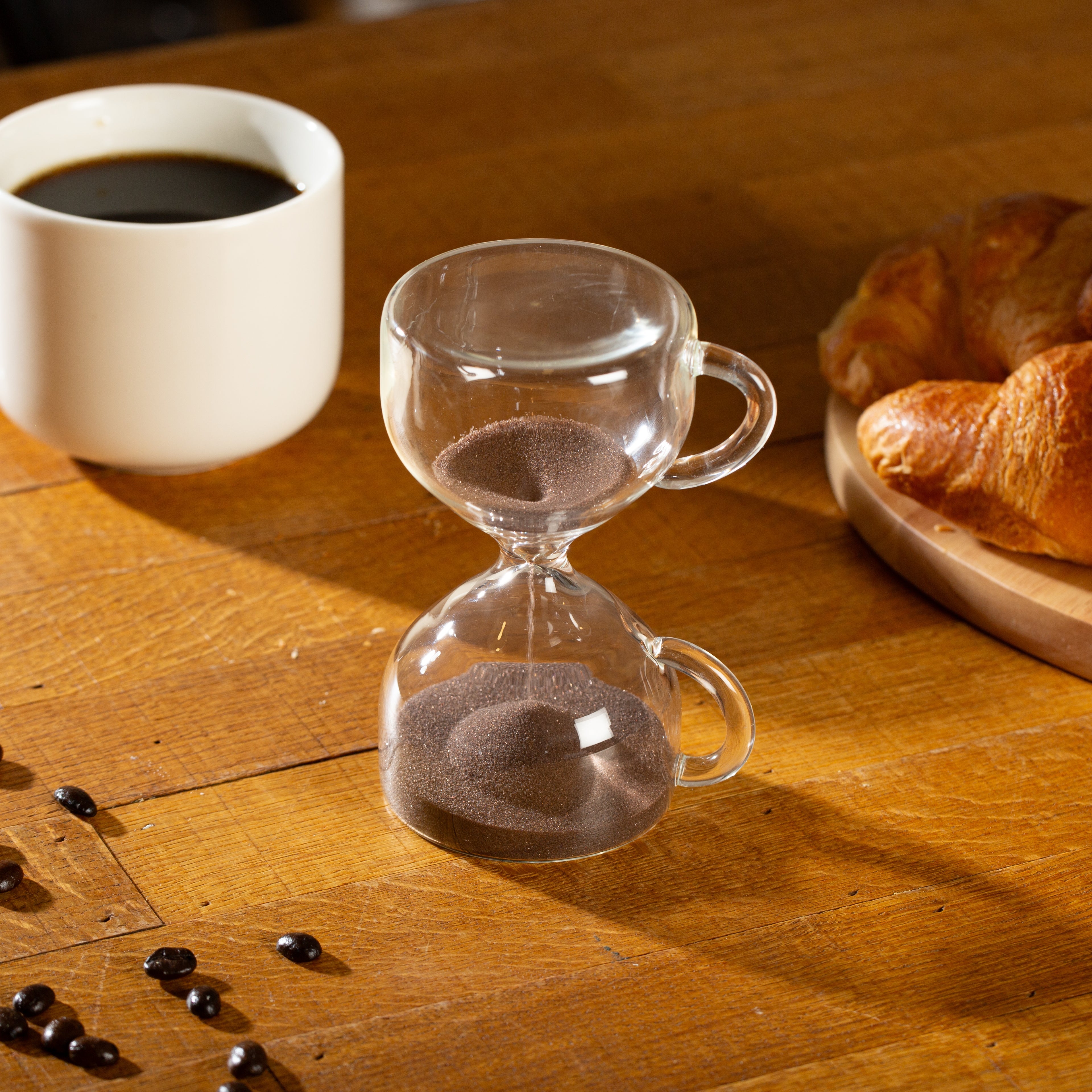 Glass hourglass sand timer with brown coffee sand and mug-shaped side handles