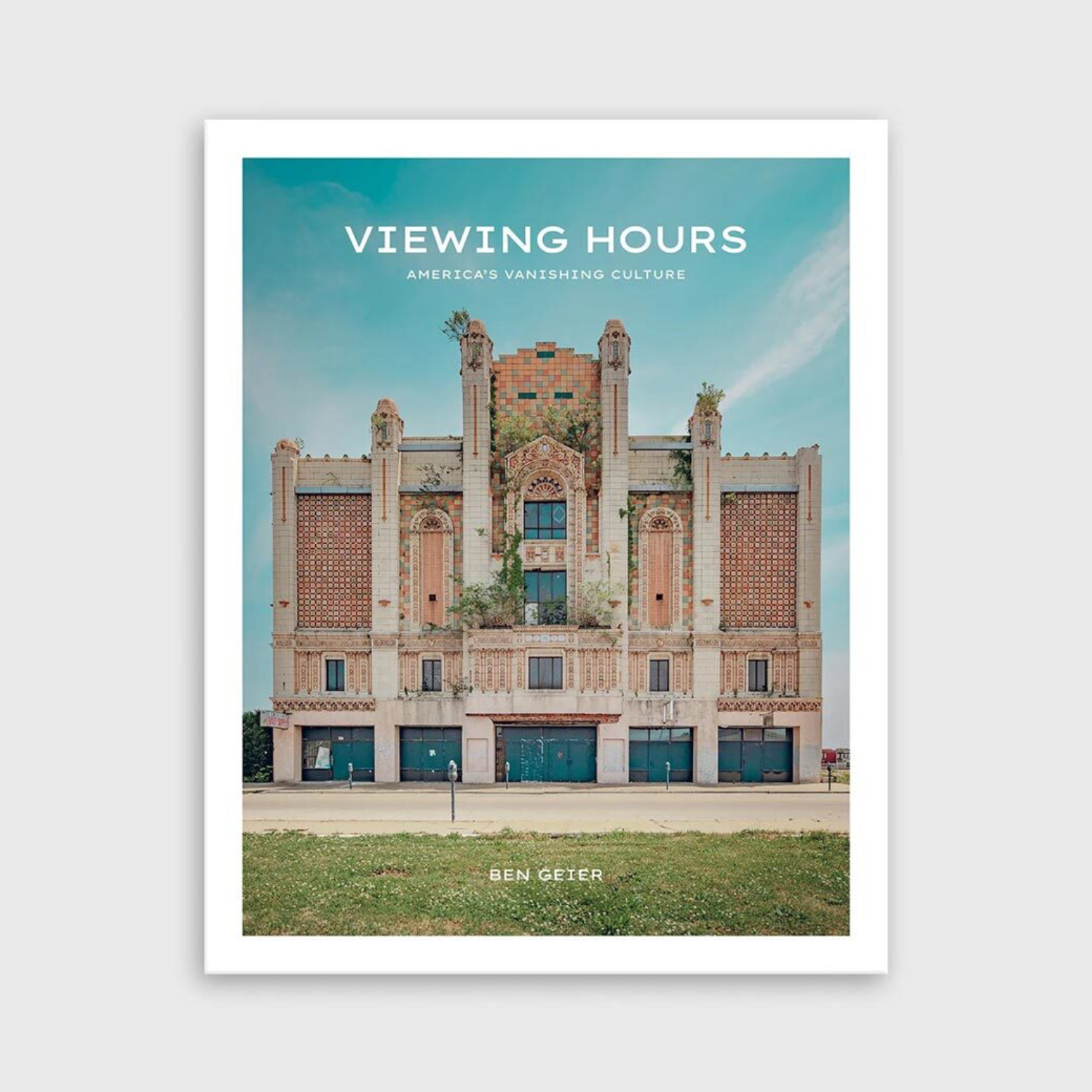 Photo book cover with ornate building facade, trees, and sky; title text at top