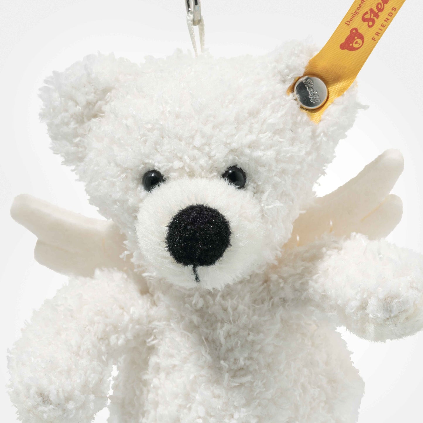 Close-up Lotte teddy bear keyring, white plush face with black nose and key clip