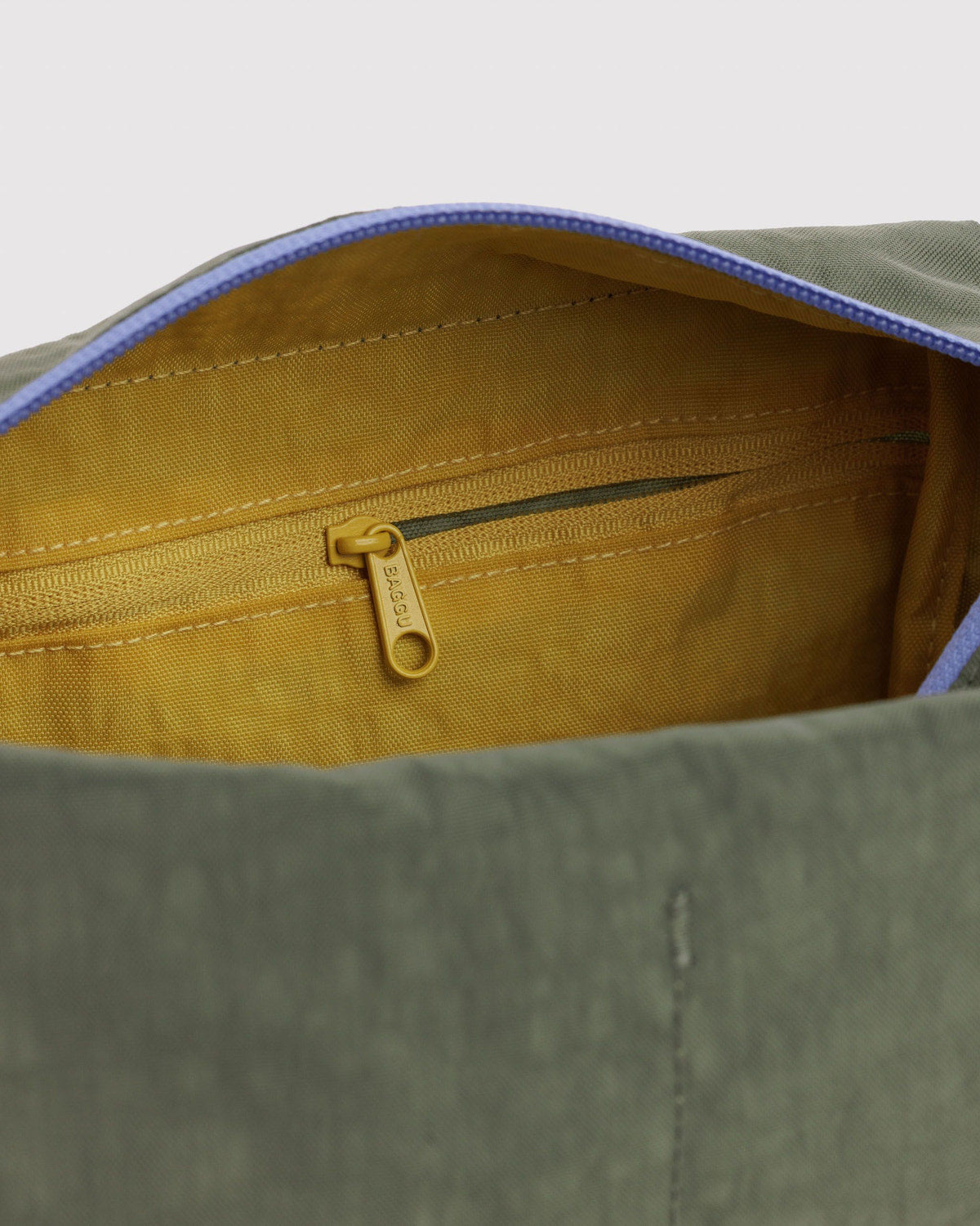 Olive dopp kit interior view with mustard lining and metal zipper pull