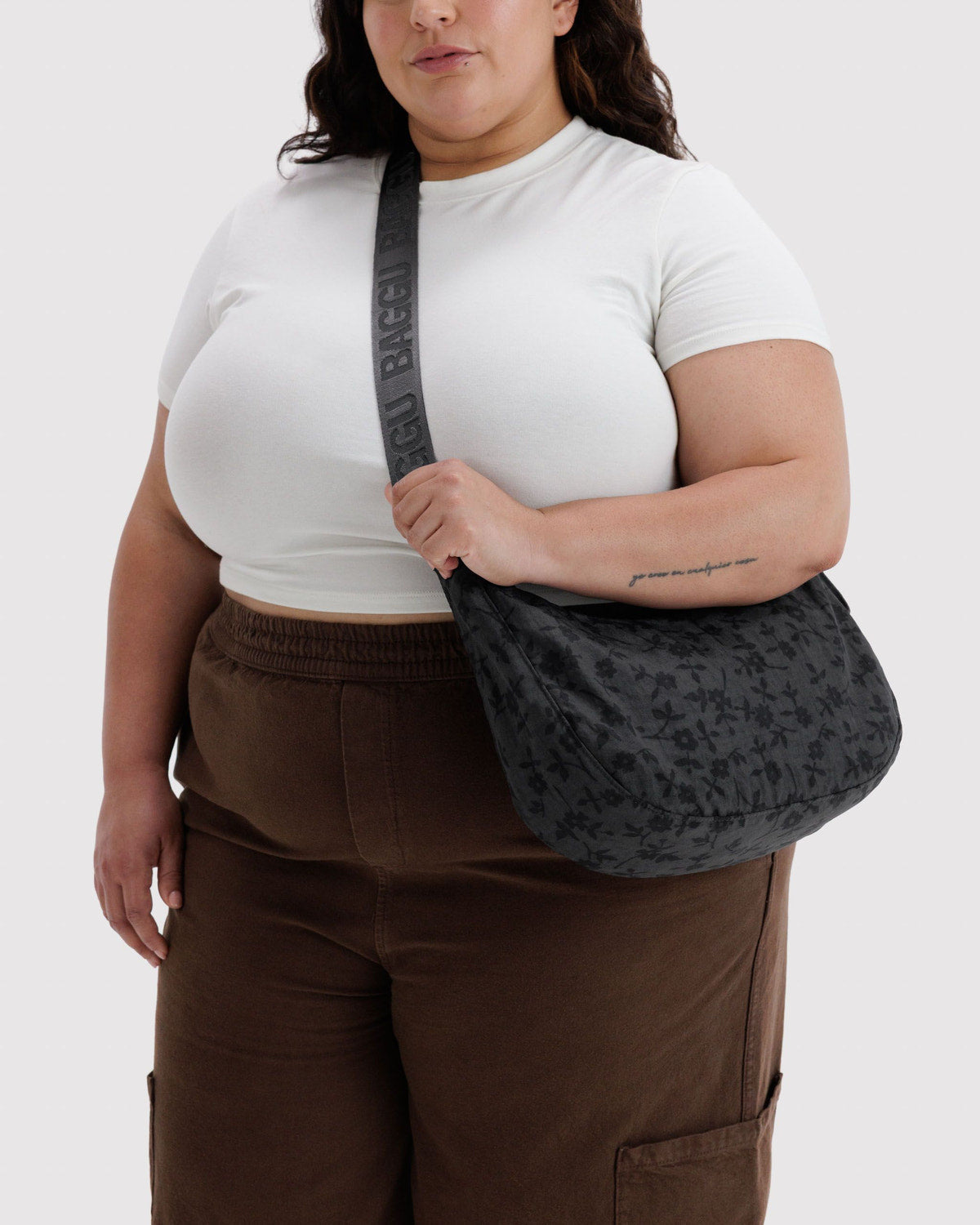 Medium crescent nylon bag in dark charcoal, with top zipper and adjustable strap