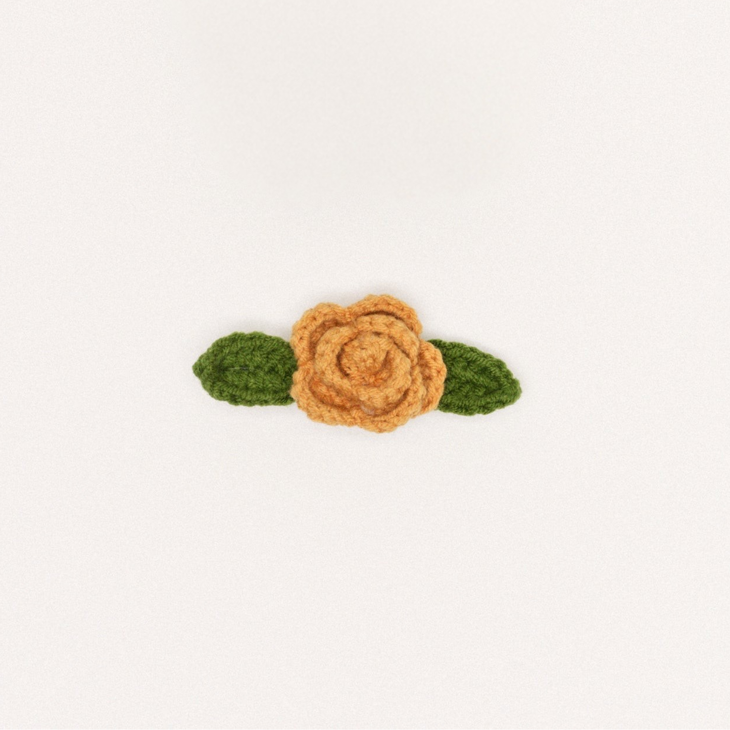 Camel crochet rose hair clip with two green leaf accents