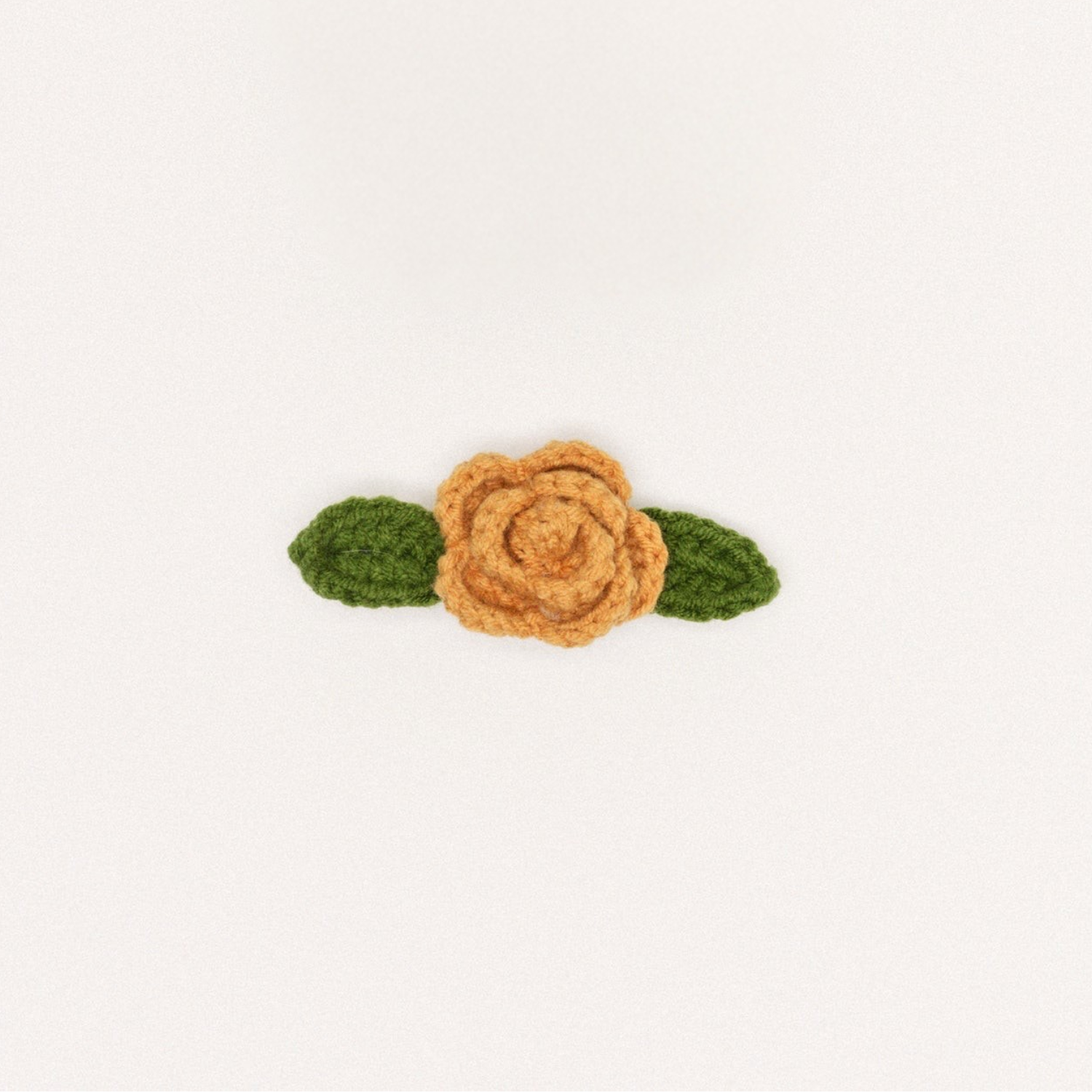 Camel crochet rose hair clip with two green leaf accents